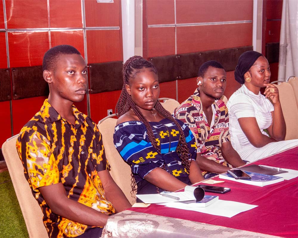Four people sit at a Benin Chapter Universal Acceptance event
