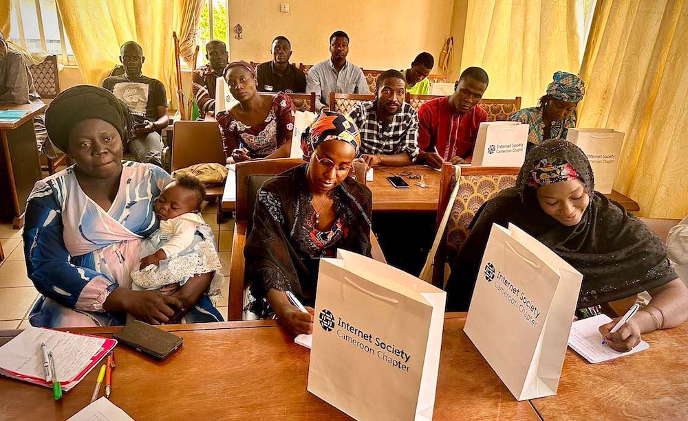 A group of men and women sit in a training