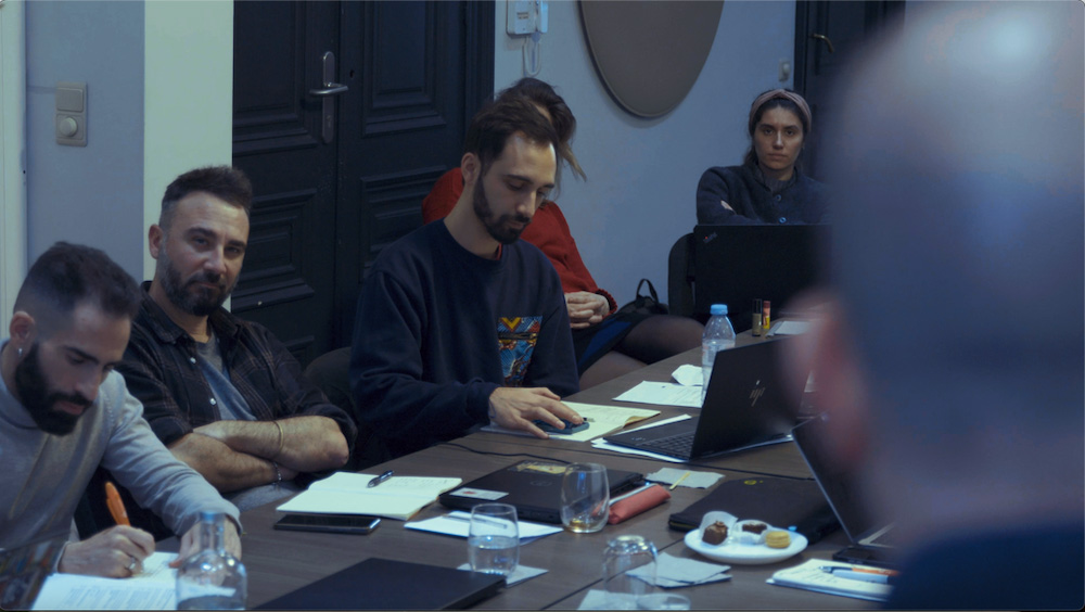 A group of people sit at a table at an encryption workshop in Brussels.