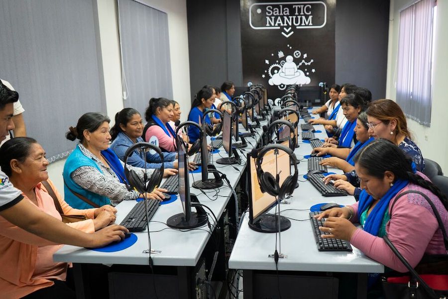 a group of women surfing the Internet in a huge conference room